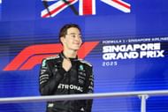 George Russell (GBR) stands on the top step of the podium after winning the 2025 Formula 1 Singapore Grand Prix, round 18 of the 2025 FIA Formula 1 World Championship - Source: Getty